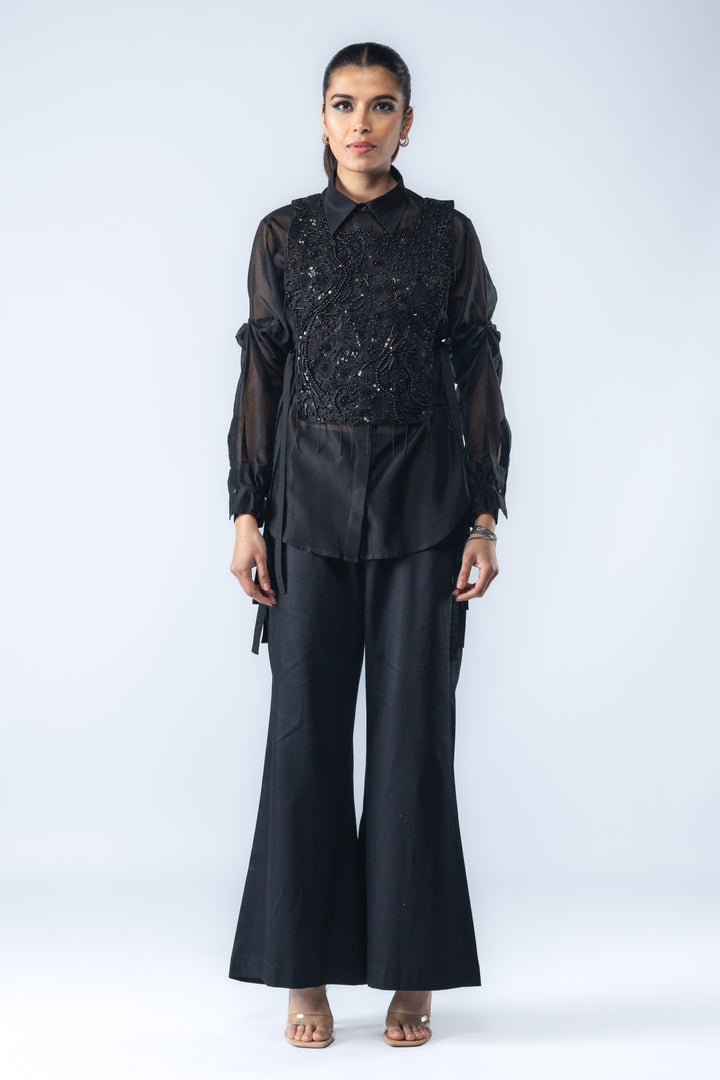 A Chanderi silk shirt and bell pants, paired with a hand-embroidered bib - Black