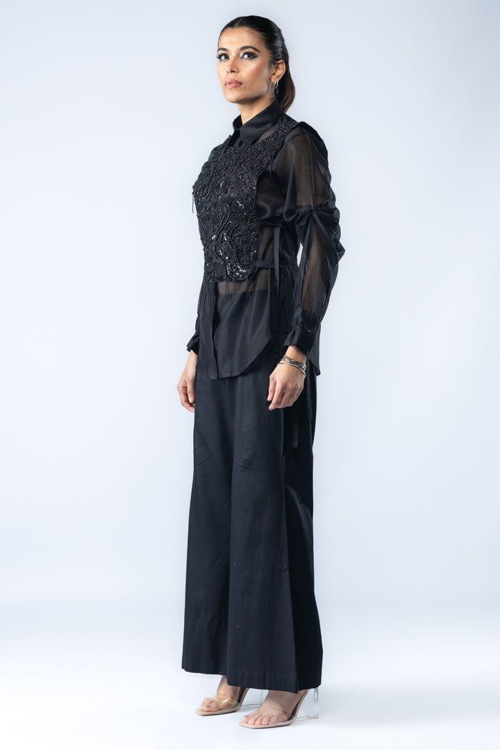 A Chanderi silk shirt and bell pants, paired with a hand-embroidered bib - Black