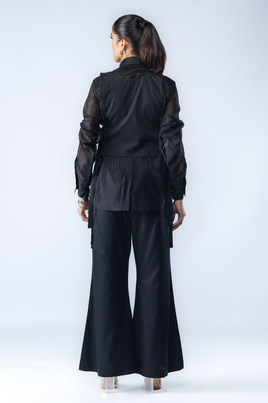 A Chanderi silk shirt and bell pants, paired with a hand-embroidered bib - Black